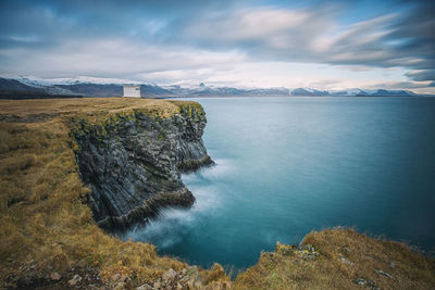 Scenic view of sea and mountains against sky