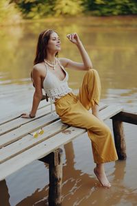 Young woman sitting in water