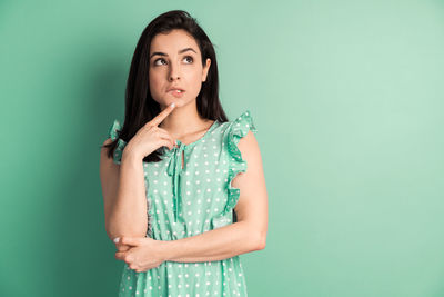 Portrait of a young woman against gray background