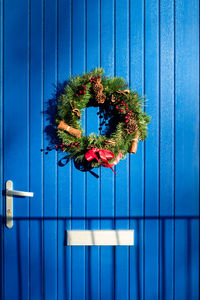 Wreath hanging on door during christmas. outdoor home decor. 