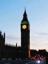 Clock tower in city against sky
