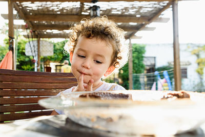 Portrait of boy with ice cream on table