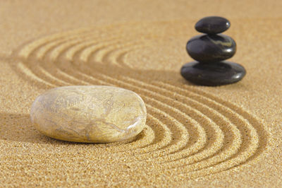 Japanese zen garden with stone in textured sand