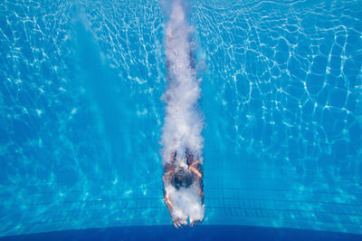 Mid adult woman swimming in pool