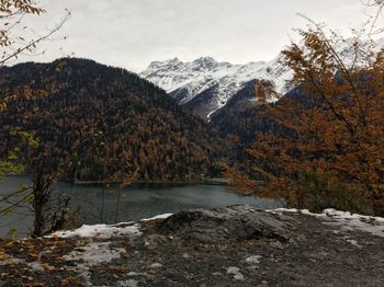 Scenic view of lake by snowcapped mountains during winter