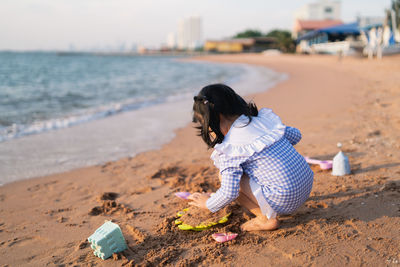 Side view of boy playing at beach