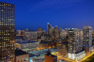 Aerial view of city lit up at night