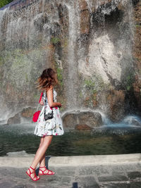 Full length of woman in water fountain