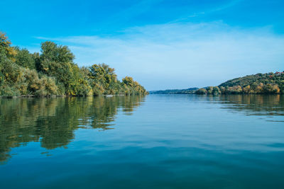 Scenic view of lake against blue sky