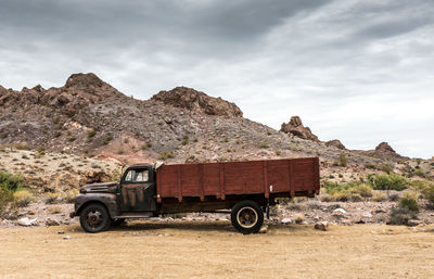 Vintage car against mountain range