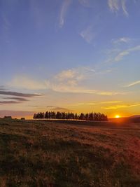 Scenic view of field against sky during sunset