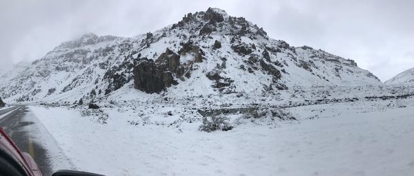 Scenic view of snow covered mountains against sky