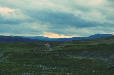 Scenic view of mountains against cloudy sky