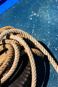 High angle view of rope and tire on boat deck