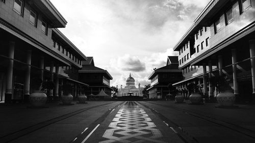 Surface level of road by buildings against sky