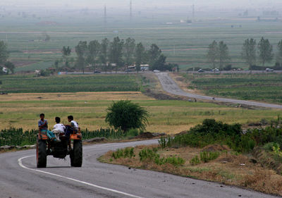 People riding motorcycle on road