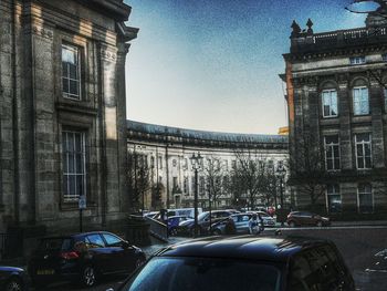 Traffic on road against buildings in city