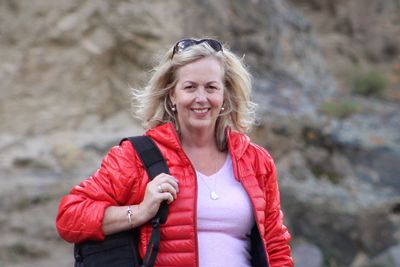 Portrait of smiling mature woman standing on land