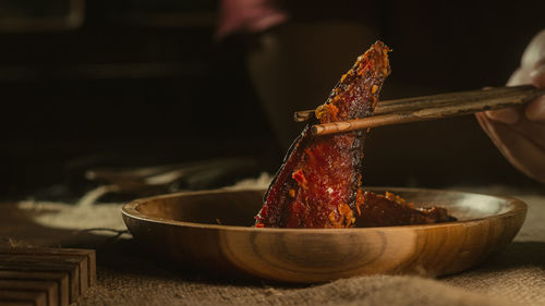 Cropped hand of person preparing food