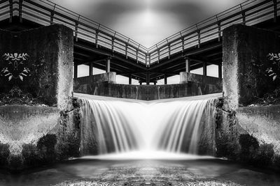 Scenic view of waterfall against sky