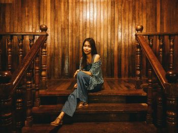 Portrait of young woman sitting on staircase
