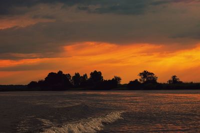 Scenic view of silhouette trees against sky during sunset