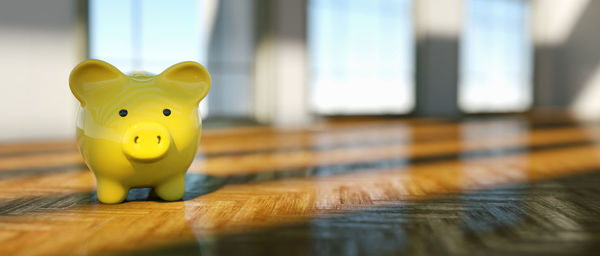 Close-up of yellow toy on wooden table