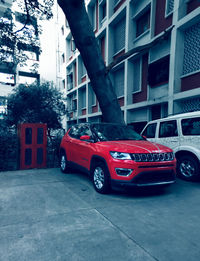 Car on street against buildings in city