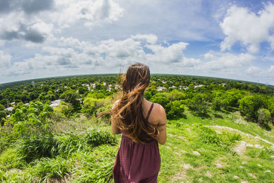 Rear view of woman standing against sky