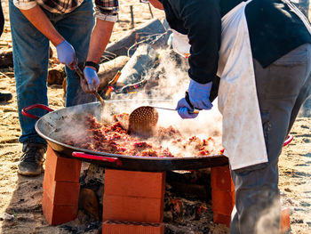 People preparing food at market stall