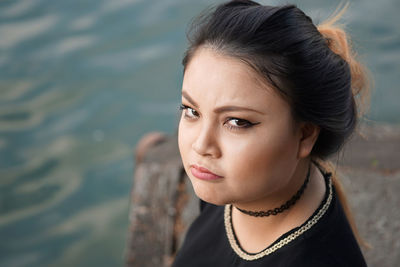 Portrait of beautiful woman by lake