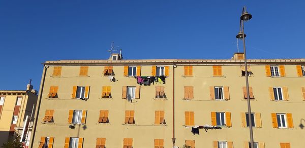 Low angle view of building against clear blue sky