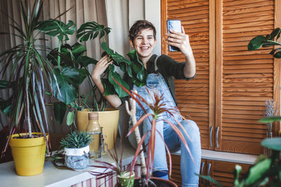 Portrait of young woman sitting on table