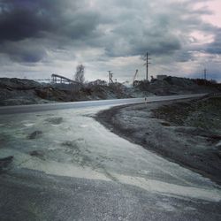 Road by landscape against sky