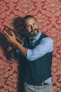 Portrait of man standing against wall