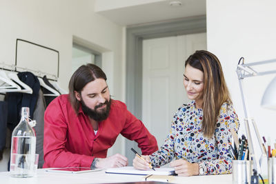 Business colleagues planning strategy at desk in creative office