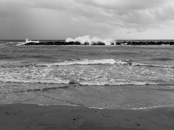 Scenic view of sea against cloudy sky