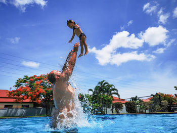 Father and daughter have fun in the pool
