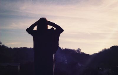 Silhouette woman against tree during sunset