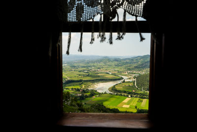 Scenic view of landscape seen through window