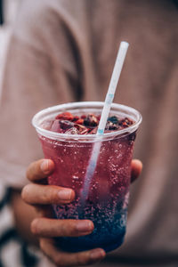 Close-up of hand holding drink