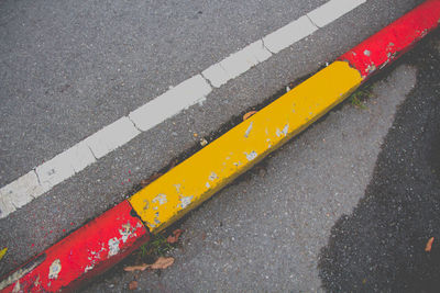 High angle view of yellow crossing sign on road