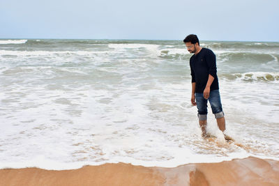 Full length of man standing on beach