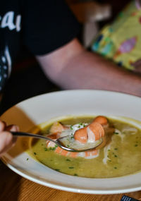 Close-up of hand holding soup
