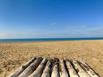 Scenic view of beach against blue sky