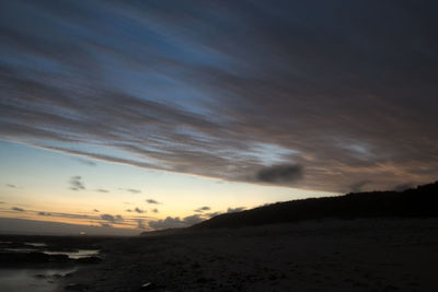 Scenic view of beach against sky during sunset