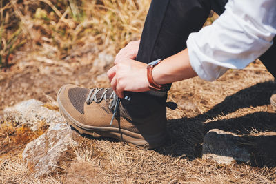 High angle view of woman tying shoelace