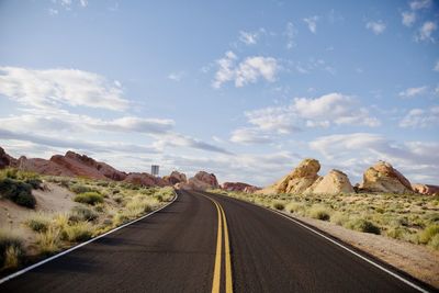 Road amidst landscape against sky