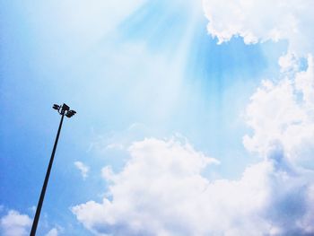 Low angle view of street light against blue sky