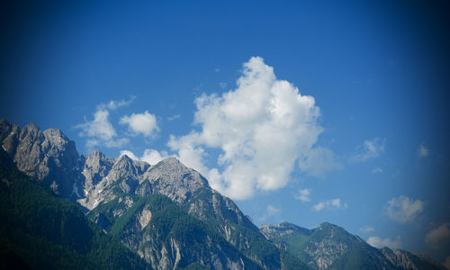 Scenic view of mountains against blue sky